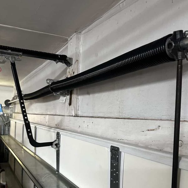 New torsion spring installed — garage door spring replacement Houston TX
